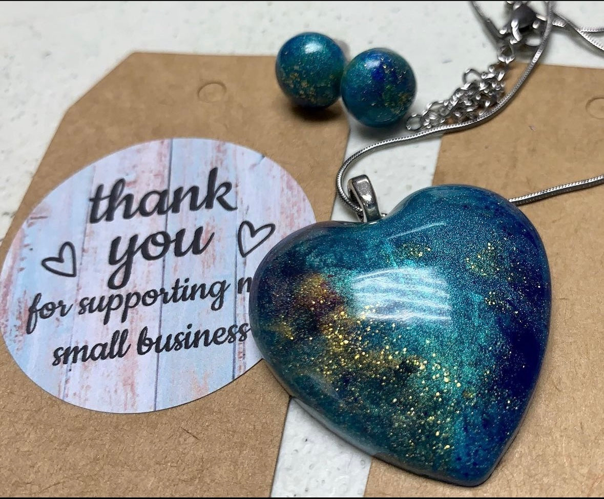 A unique heart-shape resin pendant with a special addition to any outfit or collection. blend of colors. Each piece is one of a kind,making it