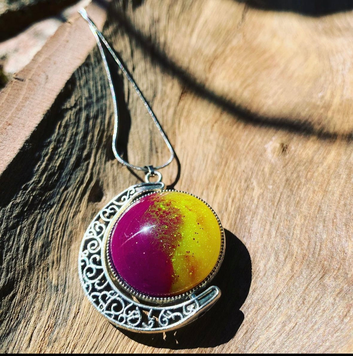 Two colorful resin charms in a rotating pendant, each piece is one-of-a-kind.